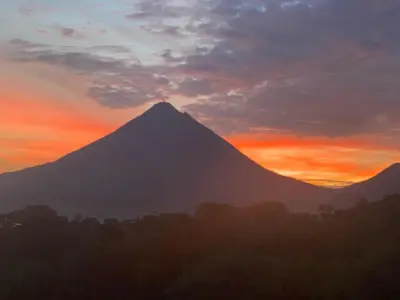 a mountain with a sunset in the background at Cabin Casove in El Castillo de La Fortuna