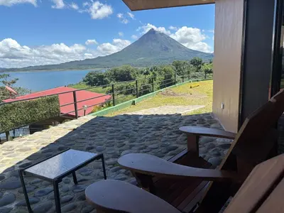 a view of a mountain from a patio with chairs at Cabin Casove in El Castillo de La Fortuna