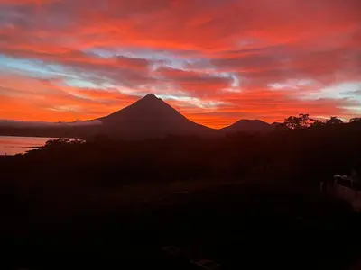 a sunset with a mountain in the background at Cabin Casove in El Castillo de La Fortuna