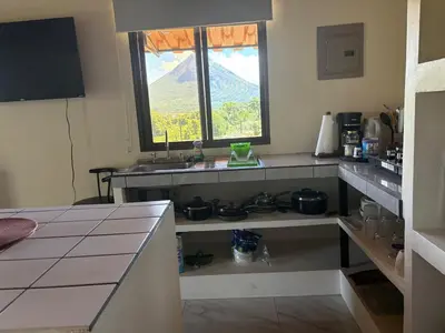a kitchen with a counter and a sink and a window at Cabin Casove in El Castillo de La Fortuna