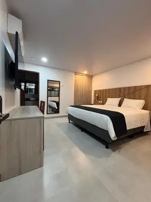a bedroom with a bed and a flat screen tv at Habitación Sabana Norte 200m Estadio Nacional San José in San José