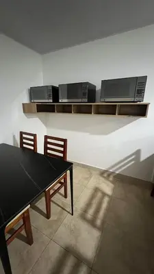 a dining room with a ping pong table and two microwaves at Habitación Sabana Norte 200m Estadio Nacional San José in San José