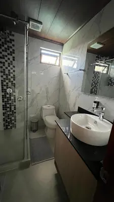 a bathroom with a sink and a shower and a toilet at Habitación Sabana Norte 200m Estadio Nacional San José in San José