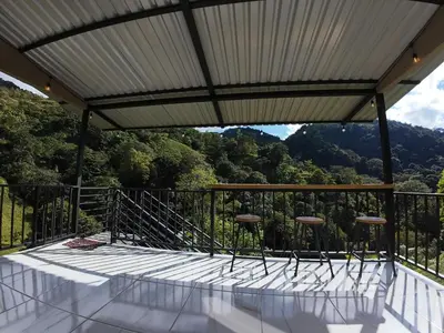 a balcony with a view of the mountains at Cabaña Brisas Del Río in Parrita