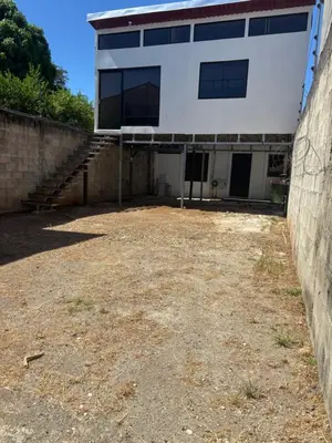 a large white building with stairs in front of it at Apartment near from Airport in Guardia