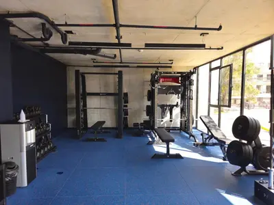 a gym with chairs and equipment in a room at 11th Floor Apartment with Sabana View Fast WiFi and AC in San José