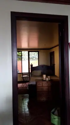 a bedroom with a bed and a dresser and a mirror at Hotel casa yayaz Nature Lodge in Grecia