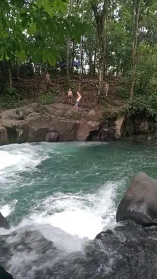 a group of people swimming in a river at La casita de chelo in Fortuna
