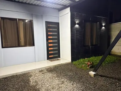 a white house with a black door and windows at La casita de chelo in Fortuna