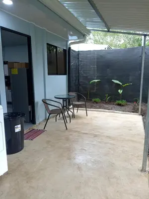 a patio with chairs and a table and a fence at La casita de chelo in Fortuna