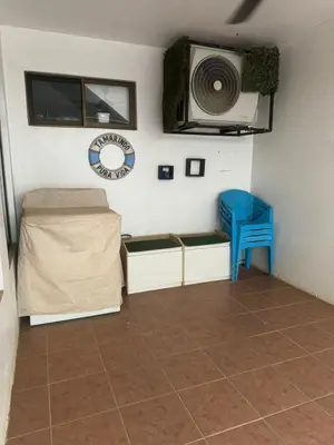 a room with a bed and a blue stool in it at Tama Magico in Tamarindo