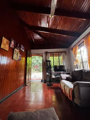 a living room with a couch and a table at Casa Marisol in Quepos