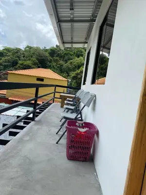 a basket sitting next to a bench on a balcony at Casa Marisol in Quepos