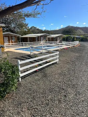 a white fence on the side of a road at Tiny Homes Tamarindo in Tamarindo