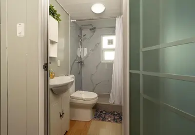 a bathroom with a toilet and a shower at Tiny Homes Tamarindo in Tamarindo