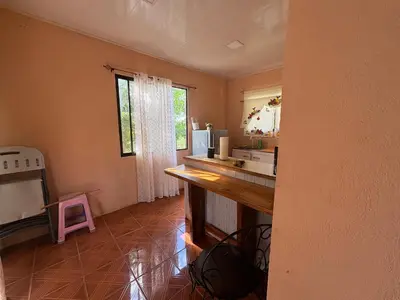 a kitchen with a counter and a sink and a window at Pura Noche Guanacaste in Marbella