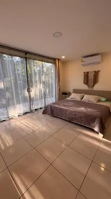 a bedroom with a bed and a large window at Miles Away Boutique Villa in Cóbano