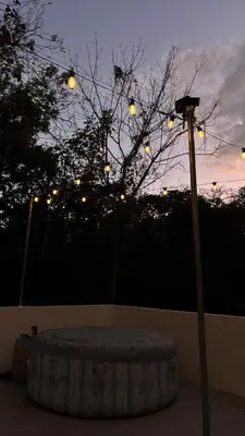 a street light next to a tree with lights at Miles Away Boutique Villa in Cóbano