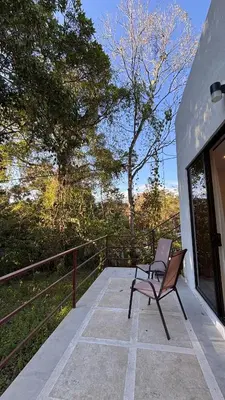 a chair sitting on a patio with a fence at Miles Away Boutique Villa in Cóbano