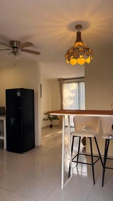 a dining room table with chairs and a ceiling fan at Miles Away Boutique Villa in Cóbano