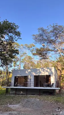 a small house in the middle of a forest at Miles Away Boutique Villa in Cóbano