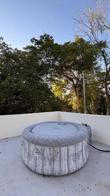 a circular bed sitting on the ground next to a wall at Miles Away Boutique Villa in Cóbano