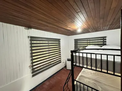 a bedroom with two bunk beds and a wooden ceiling at Beach house Punta Morales in Morales