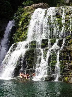 a group of people in the water at a waterfall at Vistas del Sol-Apartamento Entero in Pedregoso