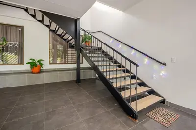 a staircase in a house with lights on the wall at Vistas del Sol-Apartamento Entero in Pedregoso