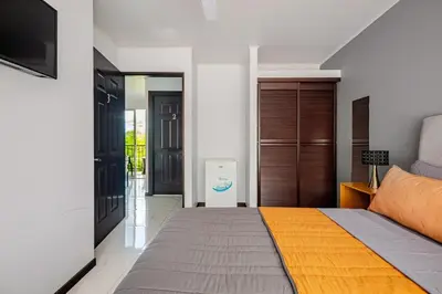 a bedroom with a bed and a tv in it at Vistas del Sol-Apartamento Entero in Pedregoso