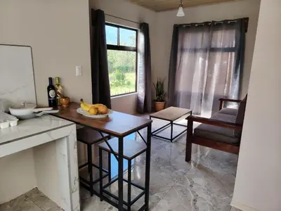 a kitchen with a table with a bowl of fruit on it at Casita Brisa Verde in Bijagua
