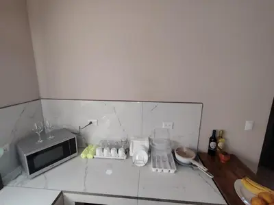 a kitchen with a counter top with a microwave at Casita Brisa Verde in Bijagua