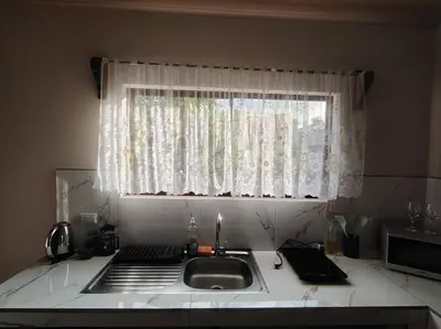 a kitchen counter with a sink and a window at Casita Brisa Verde in Bijagua