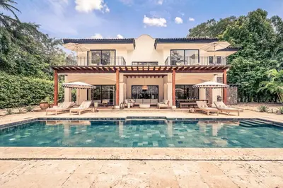 an exterior view of a house with a swimming pool at Casa Tanamera 5BR Private Retreat in Hacienda Pinilla in Tamarindo