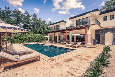 a house with a swimming pool in the yard at Casa Tanamera 5BR Private Retreat in Hacienda Pinilla in Tamarindo