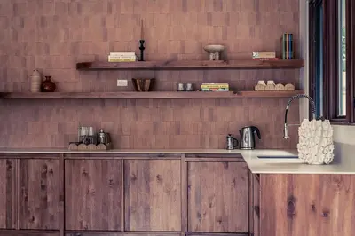 a kitchen with wooden cabinets and a sink at Casa Tanamera 5BR Private Retreat in Hacienda Pinilla in Tamarindo