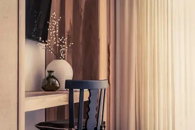 a black chair sitting on a shelf next to a curtain at Casa Tanamera 5BR Private Retreat in Hacienda Pinilla in Tamarindo
