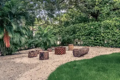 a group of logs sitting in the sand in a park at Casa Tanamera 5BR Private Retreat in Hacienda Pinilla in Tamarindo