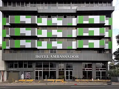 a hotel amassario building with a sign on it at Hotel Ambassador in San José