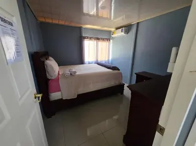 a small bedroom with a bed and a window at Apartamento DesCANsO #1 in Palmira