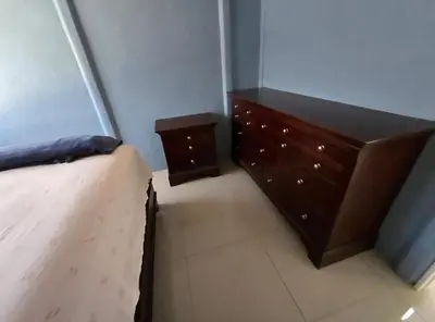 a bedroom with a bed and a wooden dresser at Apartamento DesCANsO #1 in Palmira