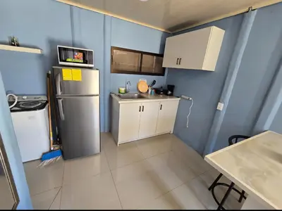 a small kitchen with a refrigerator and white cabinets at Apartamento DesCANsO #1 in Palmira