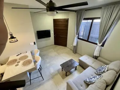 a living room with a couch and a table at Langosta apartment in Tamarindo