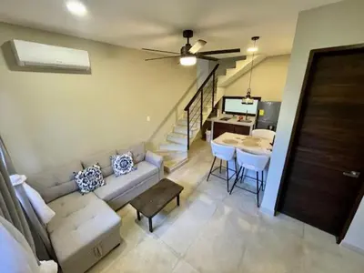 a living room with a couch and a table at Langosta apartment in Tamarindo