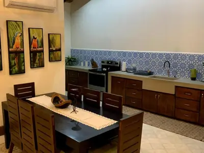 a kitchen with a table and a stove top oven at PuraVida lifestyle at Casa Caoba in Playa Flamingo
