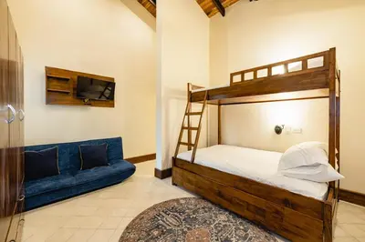 a bedroom with a bunk bed and a blue couch at PuraVida lifestyle at Casa Caoba in Playa Flamingo