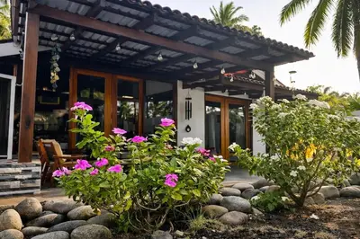a house with pink flowers in front of it at Paradise in Tivives