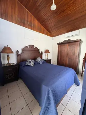 a bedroom with a blue bed with two pillows on it at Paradise in Tivives