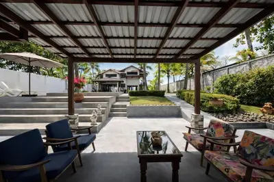 an outdoor patio with chairs and tables and a pergola at Paradise in Tivives