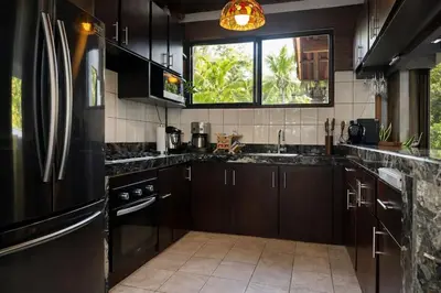 a kitchen with a black refrigerator and a window at Paradise in Tivives